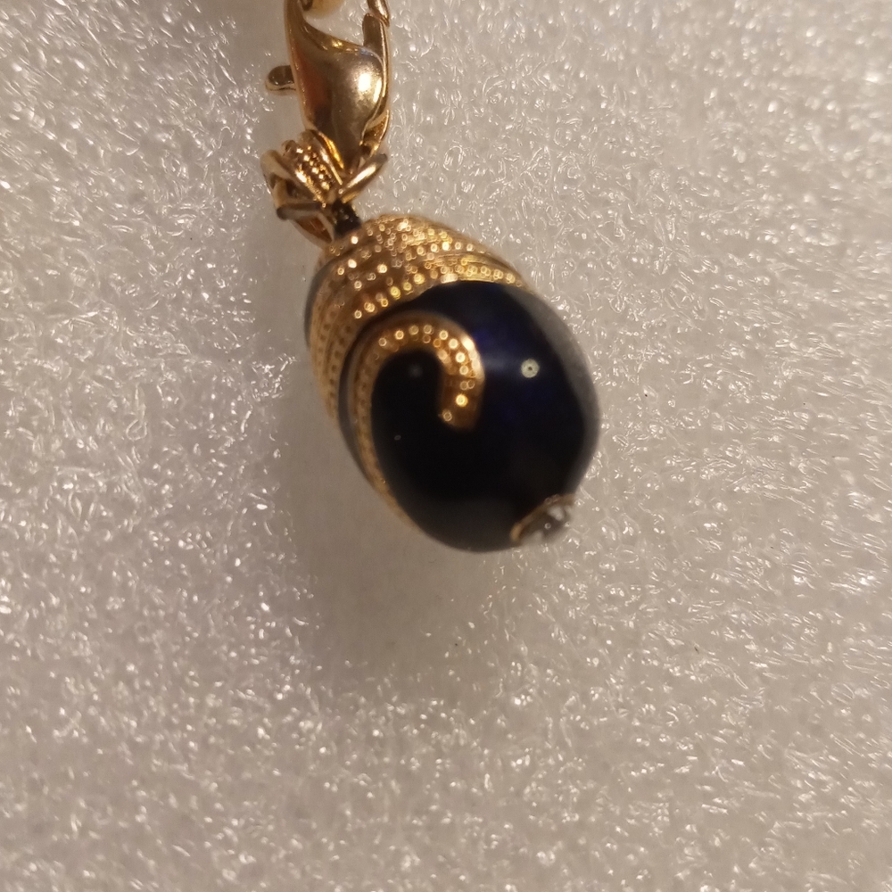Faberge egg charm bracelet on a gold tone rolo chain. - Picture 7 of 16